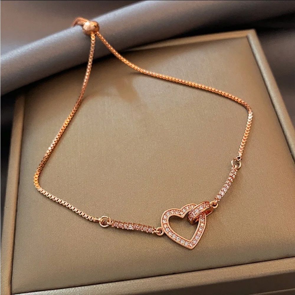 The Rose Gold Heart Chakra Slide Closure bracelet with heart pendant.